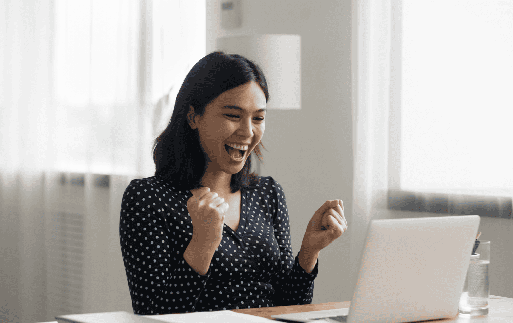 Excited woman looking at laptop screen
